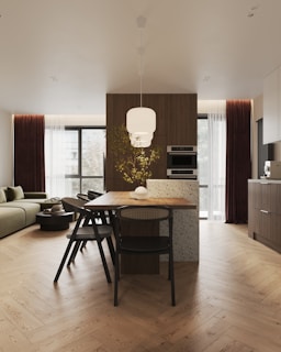 A modern kitchen and living room are shown