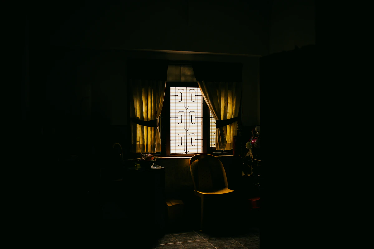 A quiet room with a chair by a window
