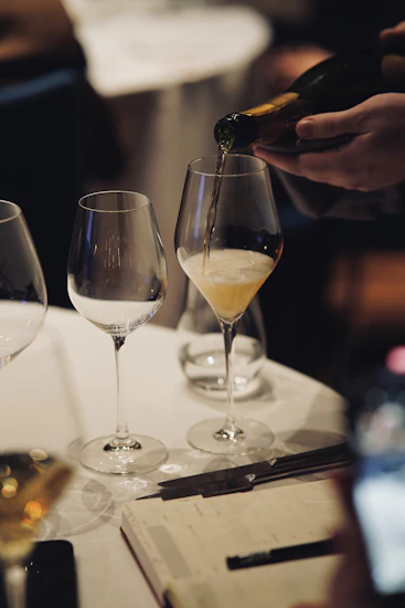Stemmed glass filled with sparkling wine on a set table
