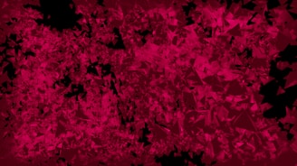 A red and black background with some black spots