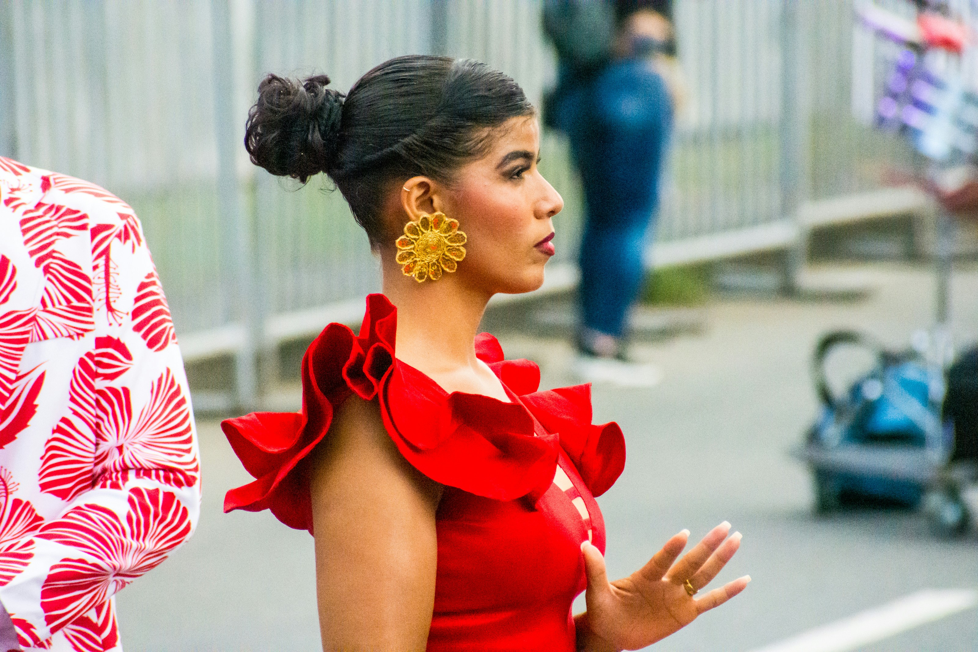 A woman in a red dress walking down the street