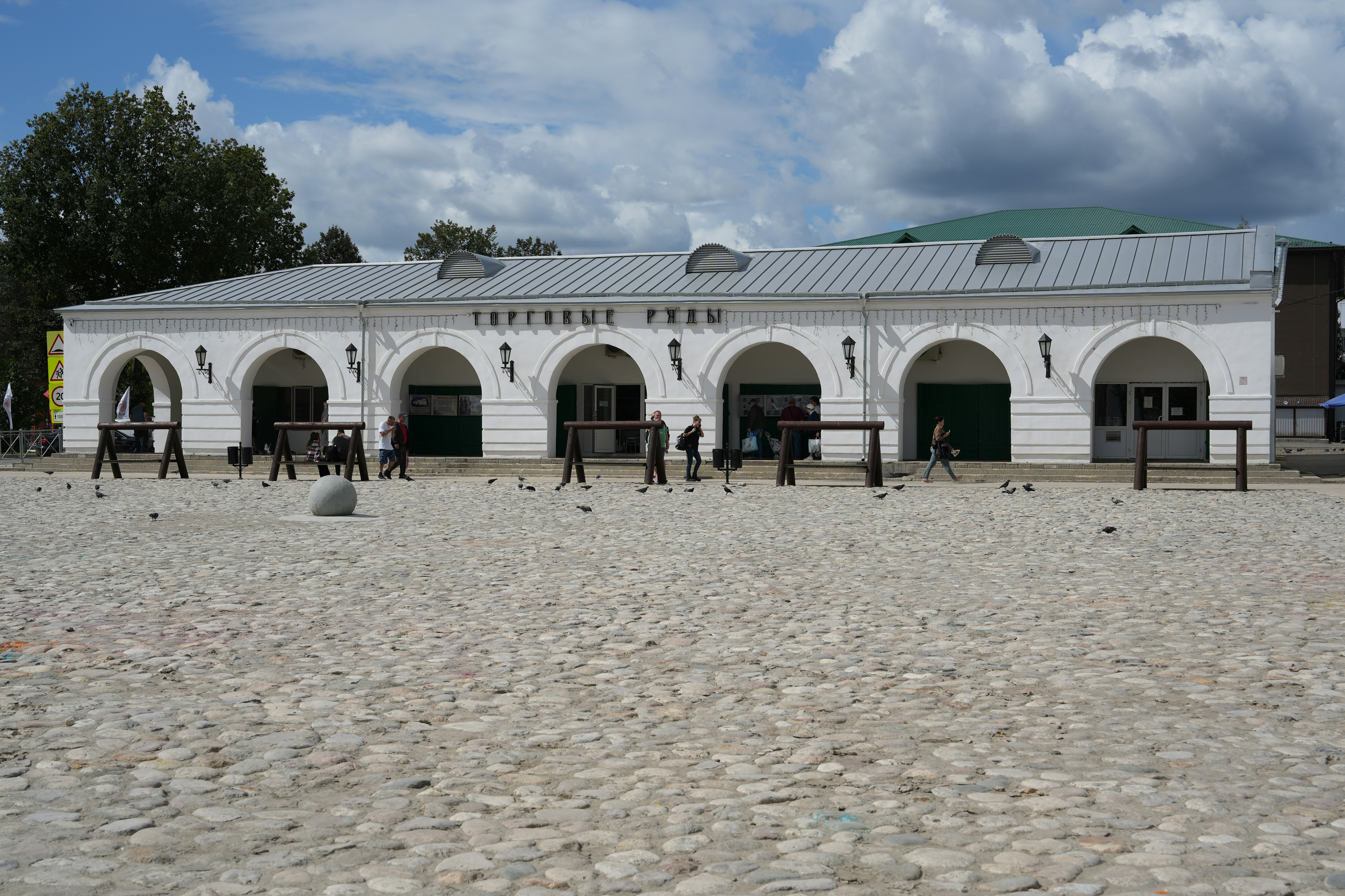 A large white building sitting on top of a sandy beach