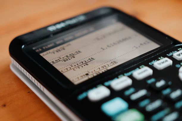 A cell phone sitting on top of a wooden table