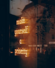 A neon sign that says make yourself on priority