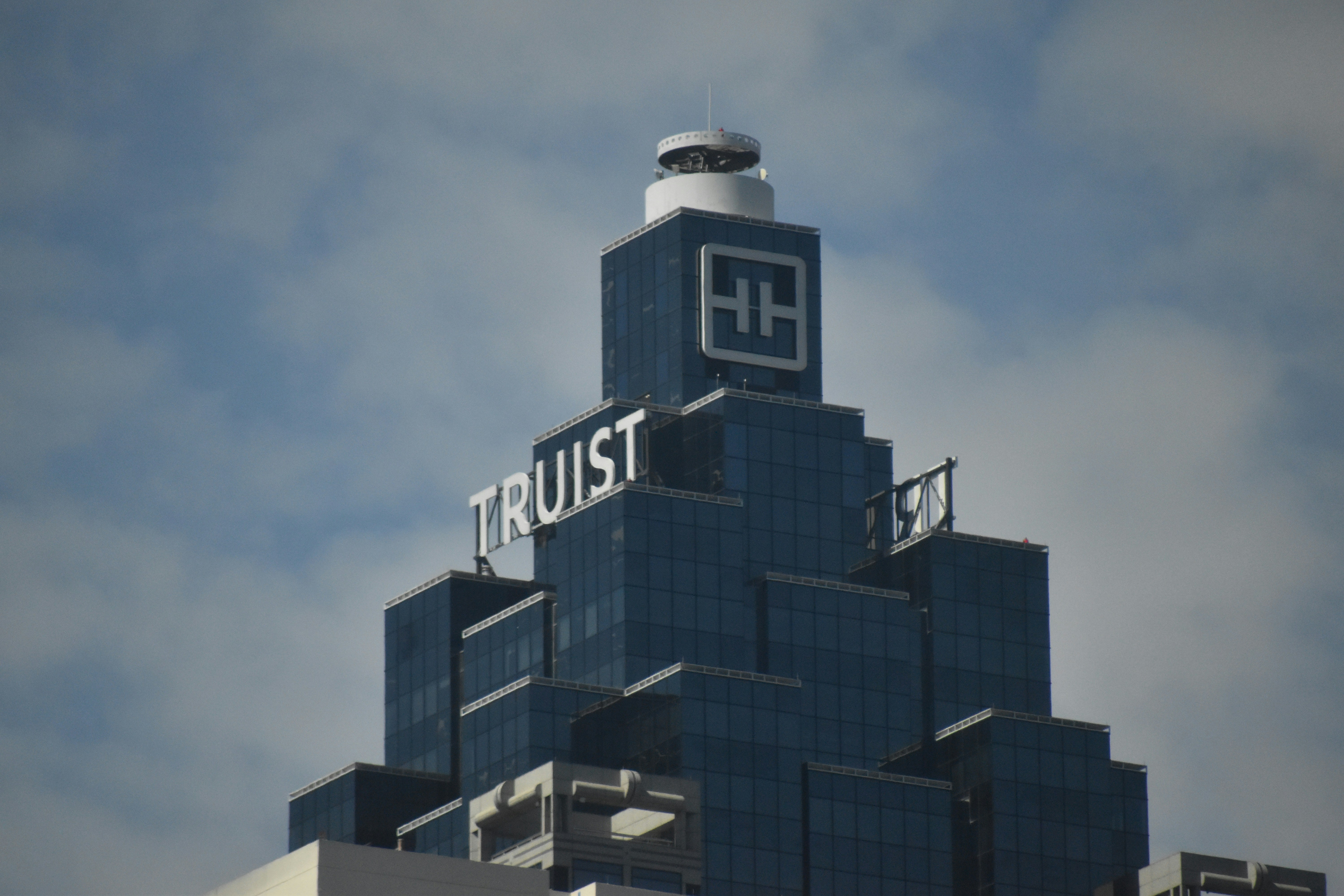 A tall building with a sign on top of it