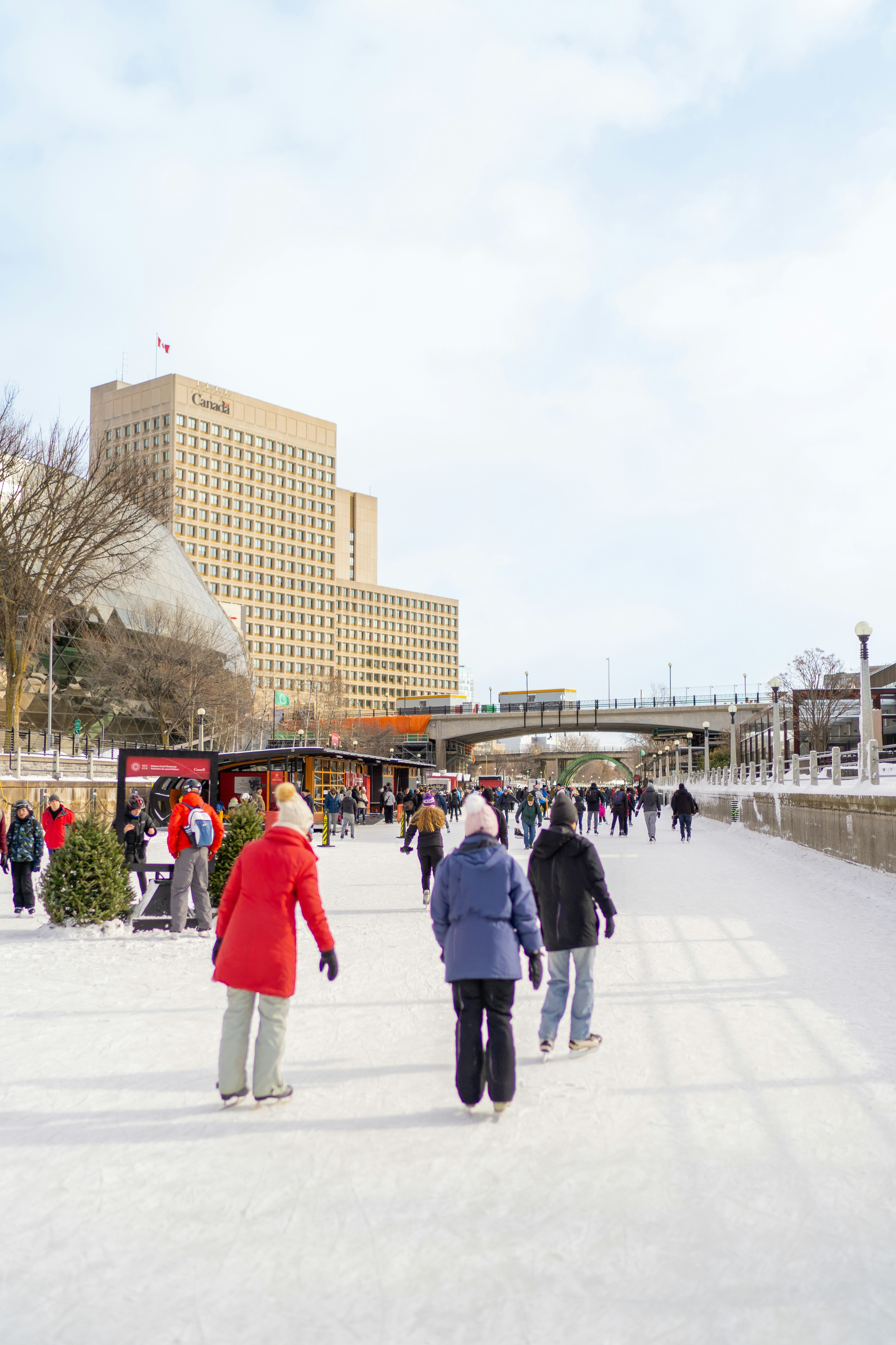 A group of people walking across a snow covered ground