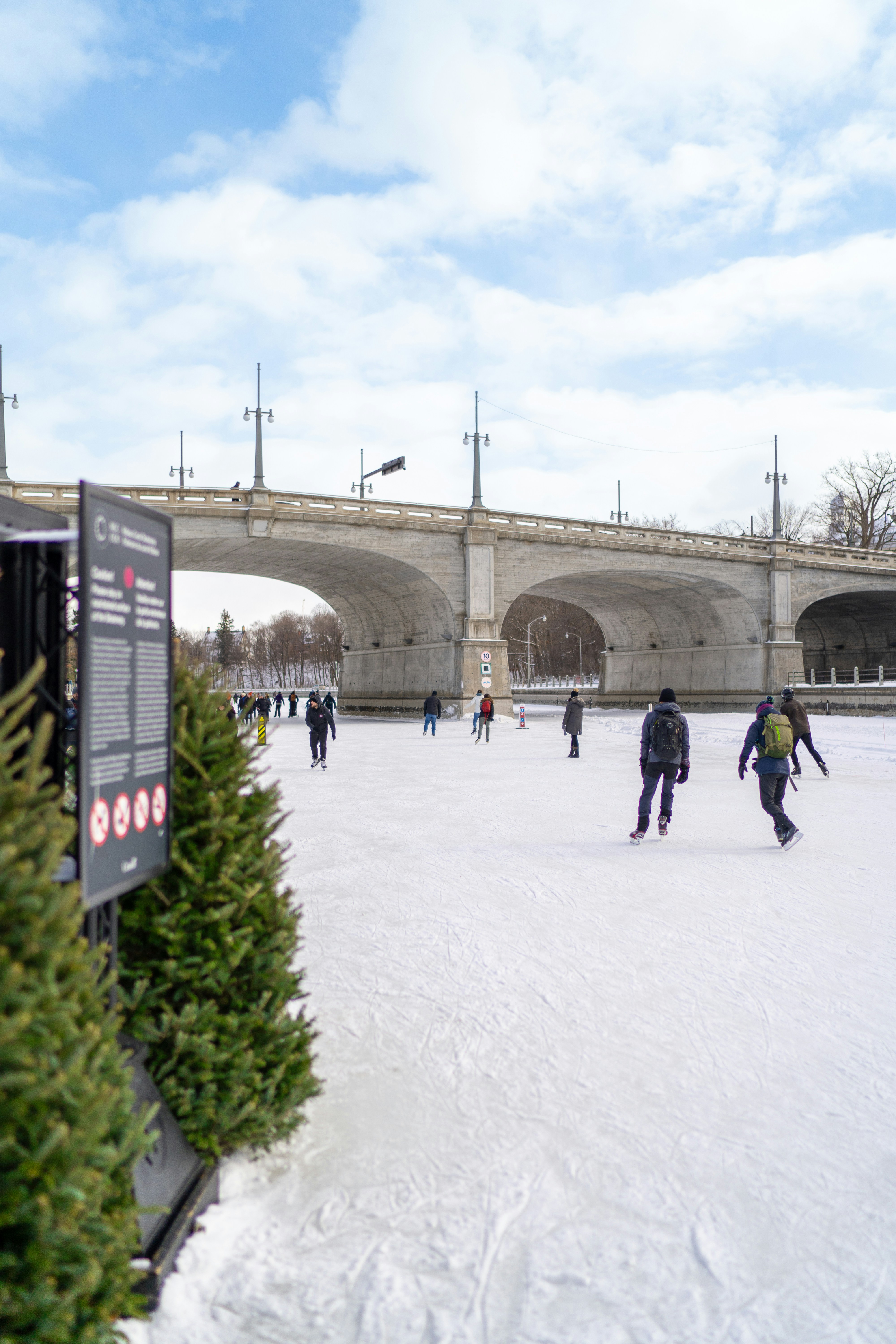 A group of people riding skis on top of snow covered ground