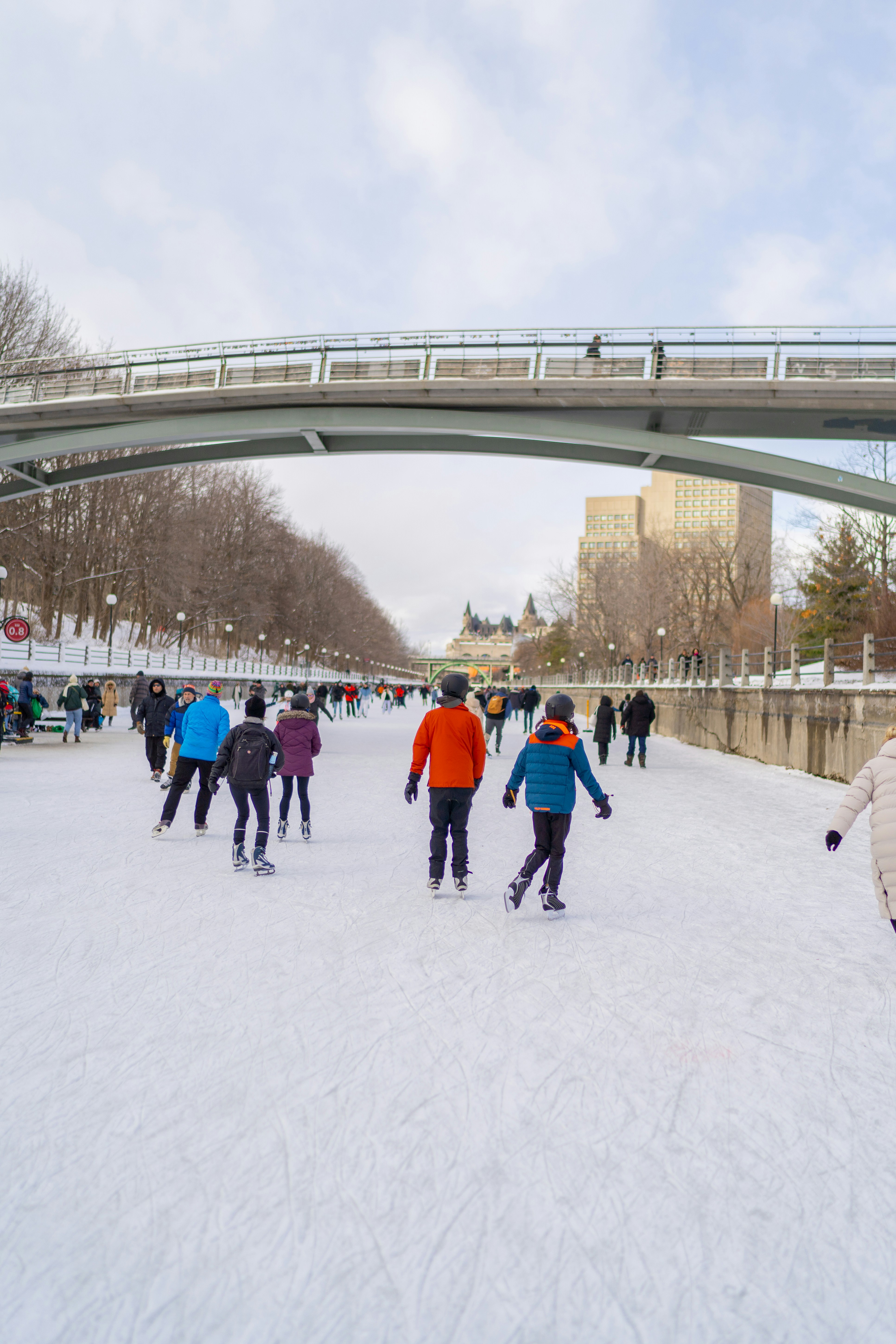 A group of people riding skis down a snow covered slope