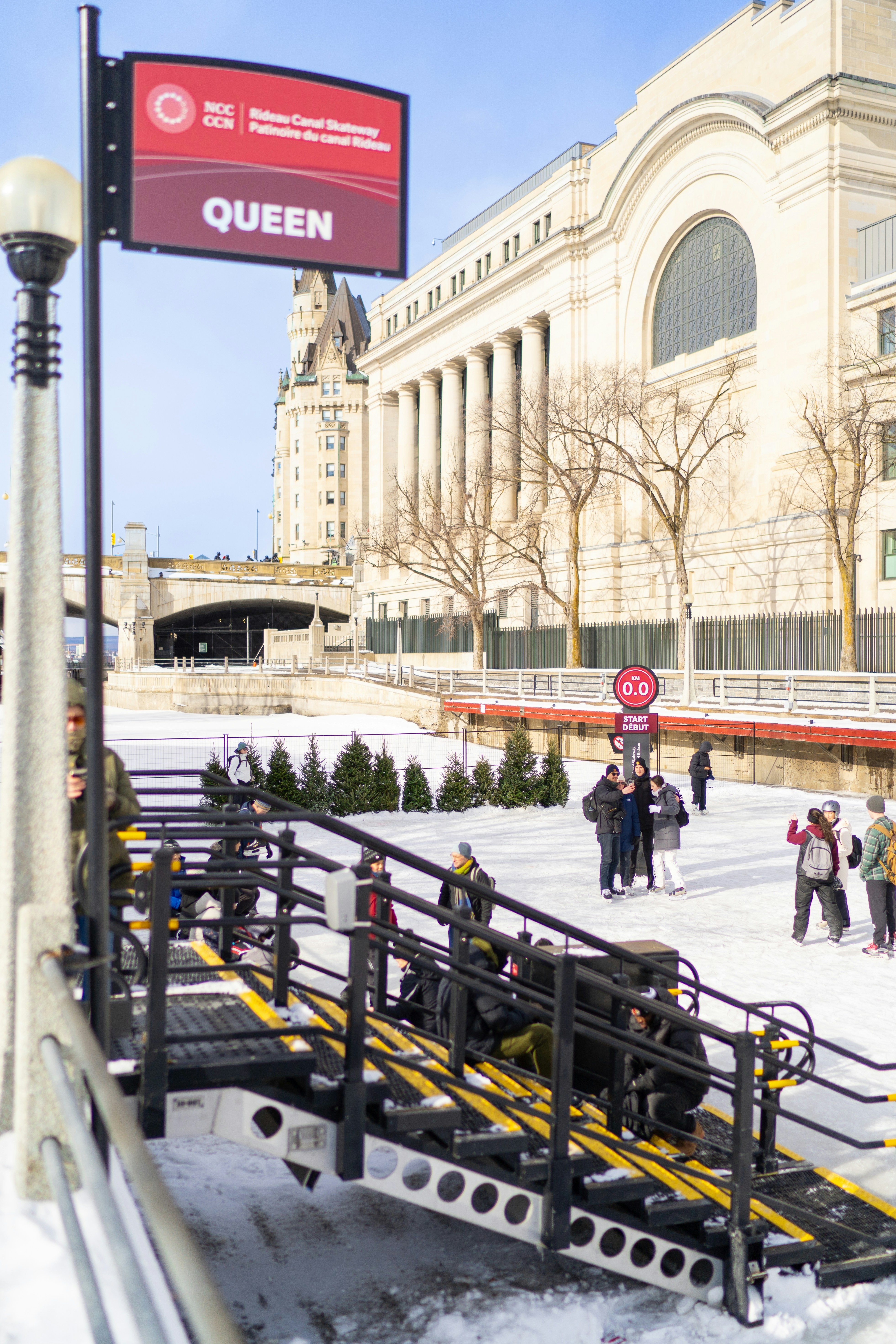 A group of people walking across a snow covered street