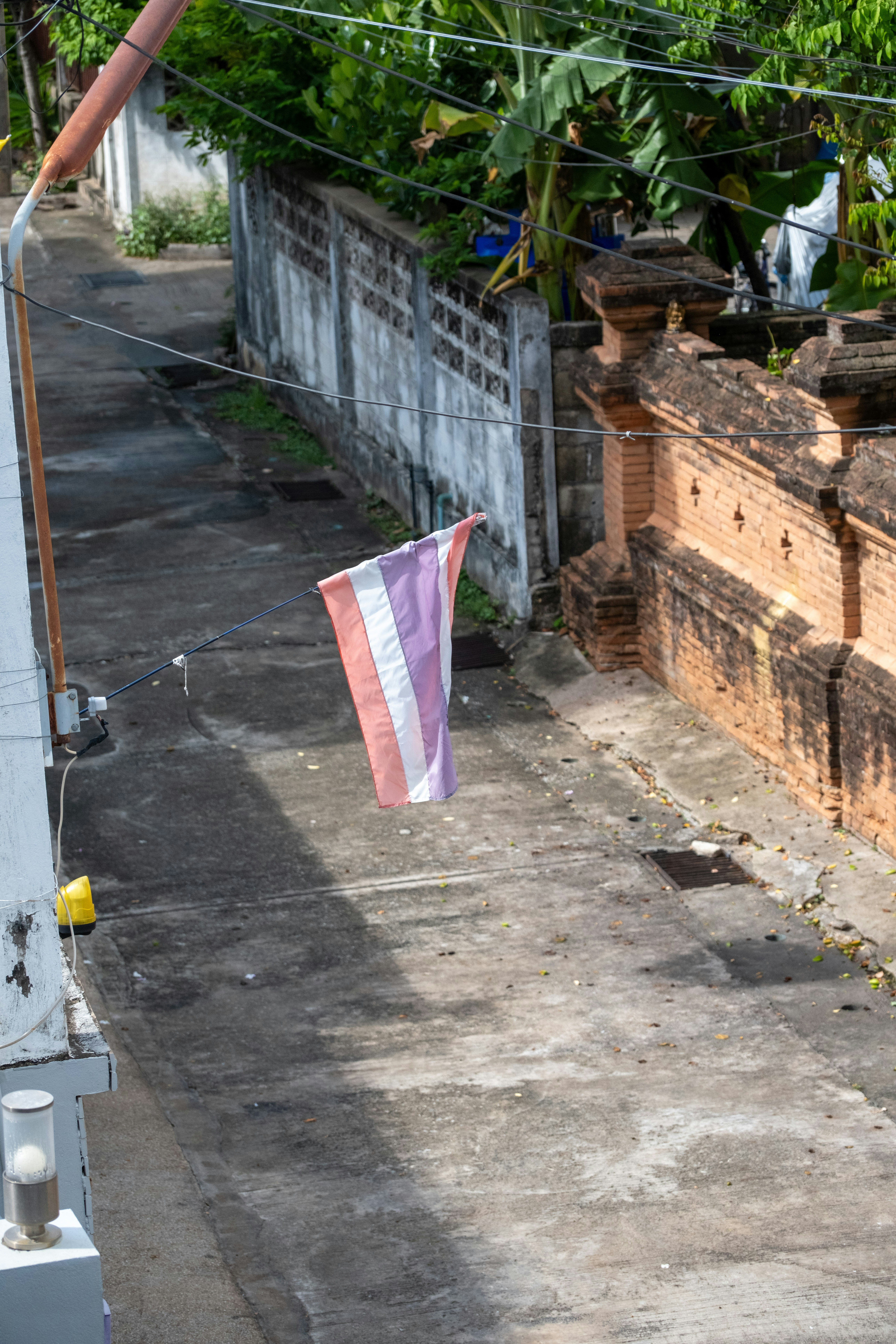 A flag hanging on a clothes line next to a building