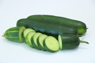 A group of cucumbers on a white surface