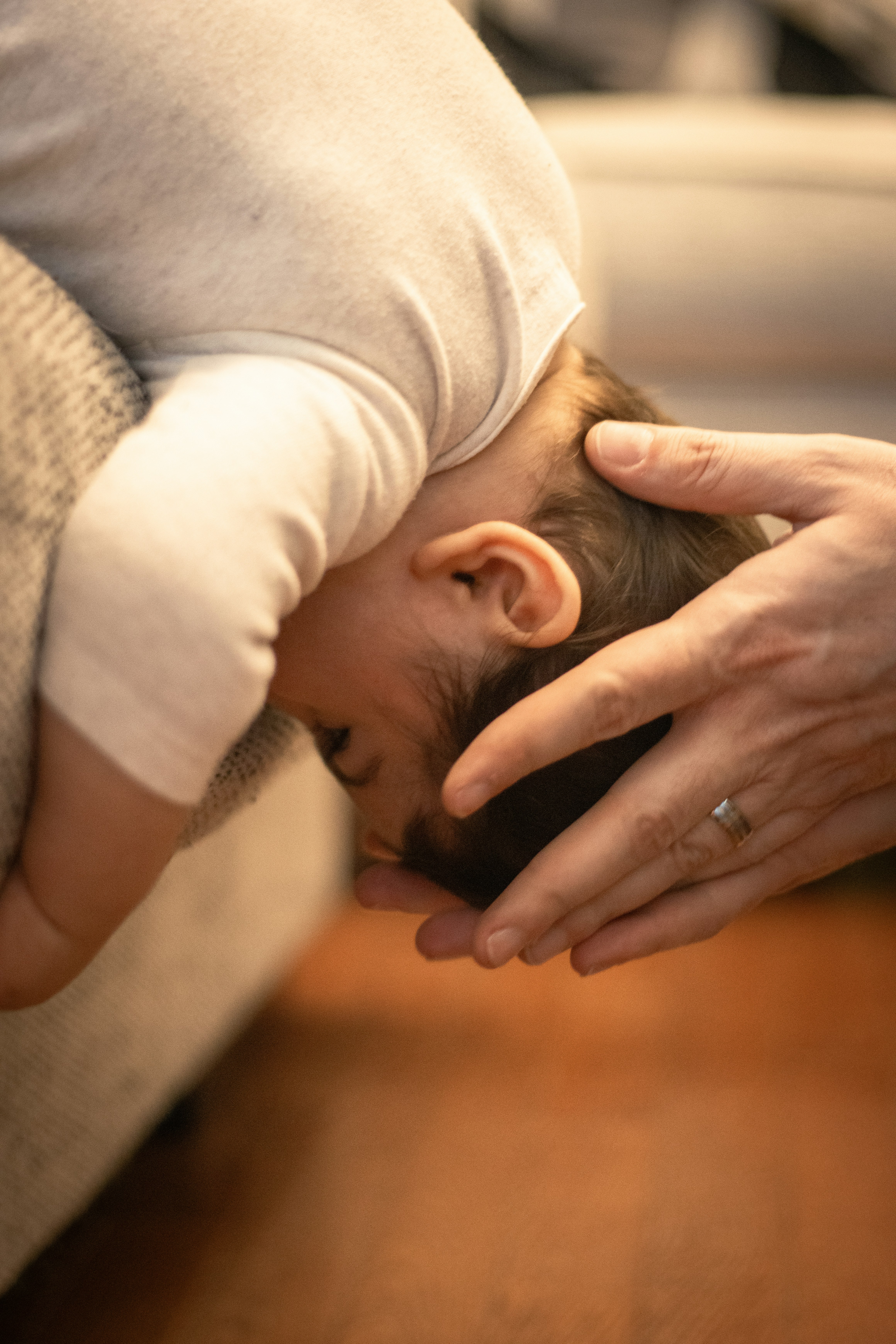 A person holding a baby in their lap