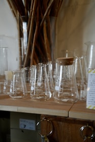 A bunch of glasses are lined up on a table