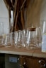 A bunch of glasses are lined up on a table
