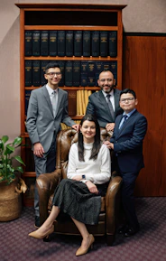 A group of people standing and sitting in a room