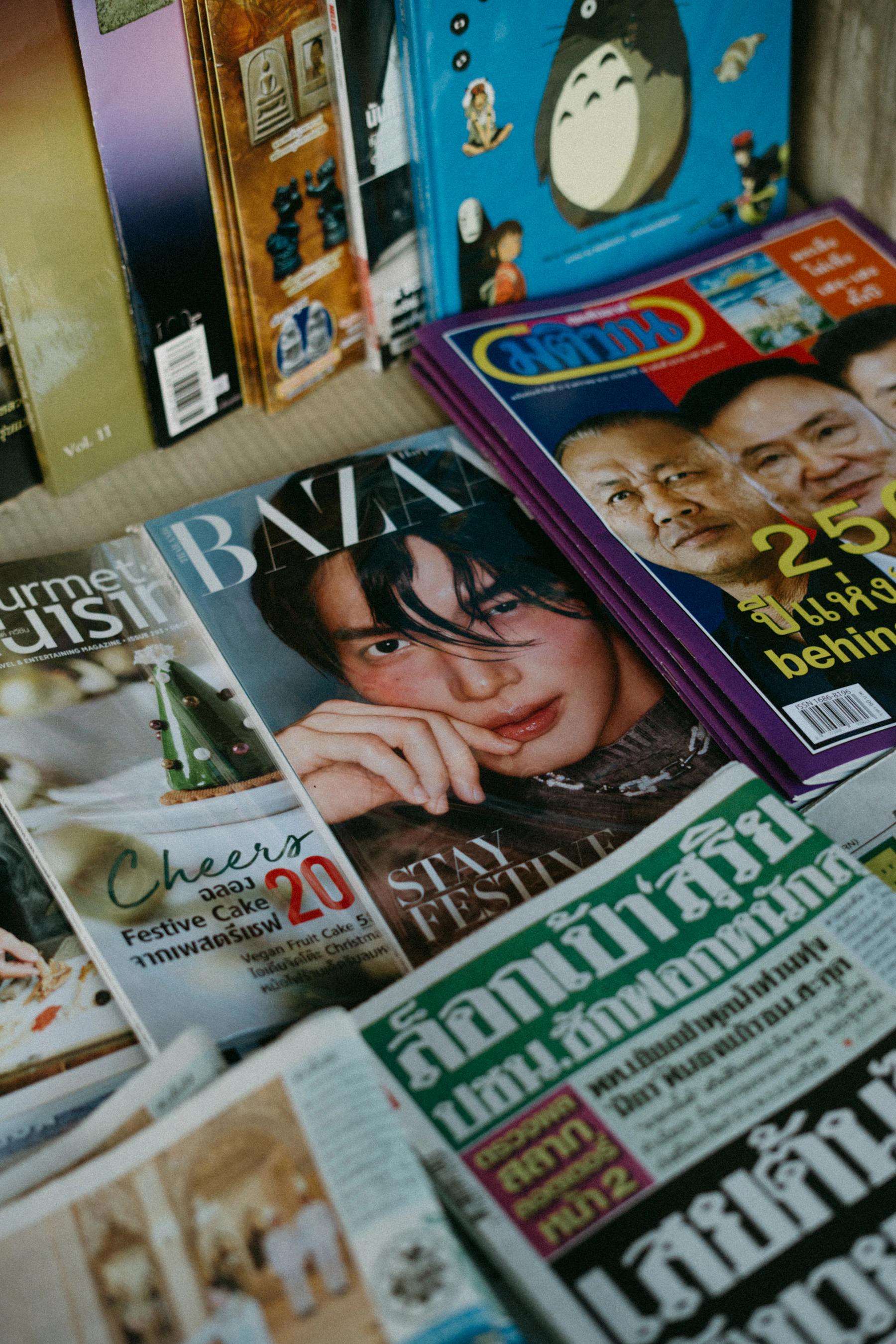 A pile of fashion magazines on a table