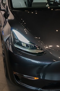 A black tesla car parked in a garage