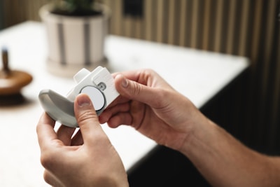 A person holding a remote control in their hand