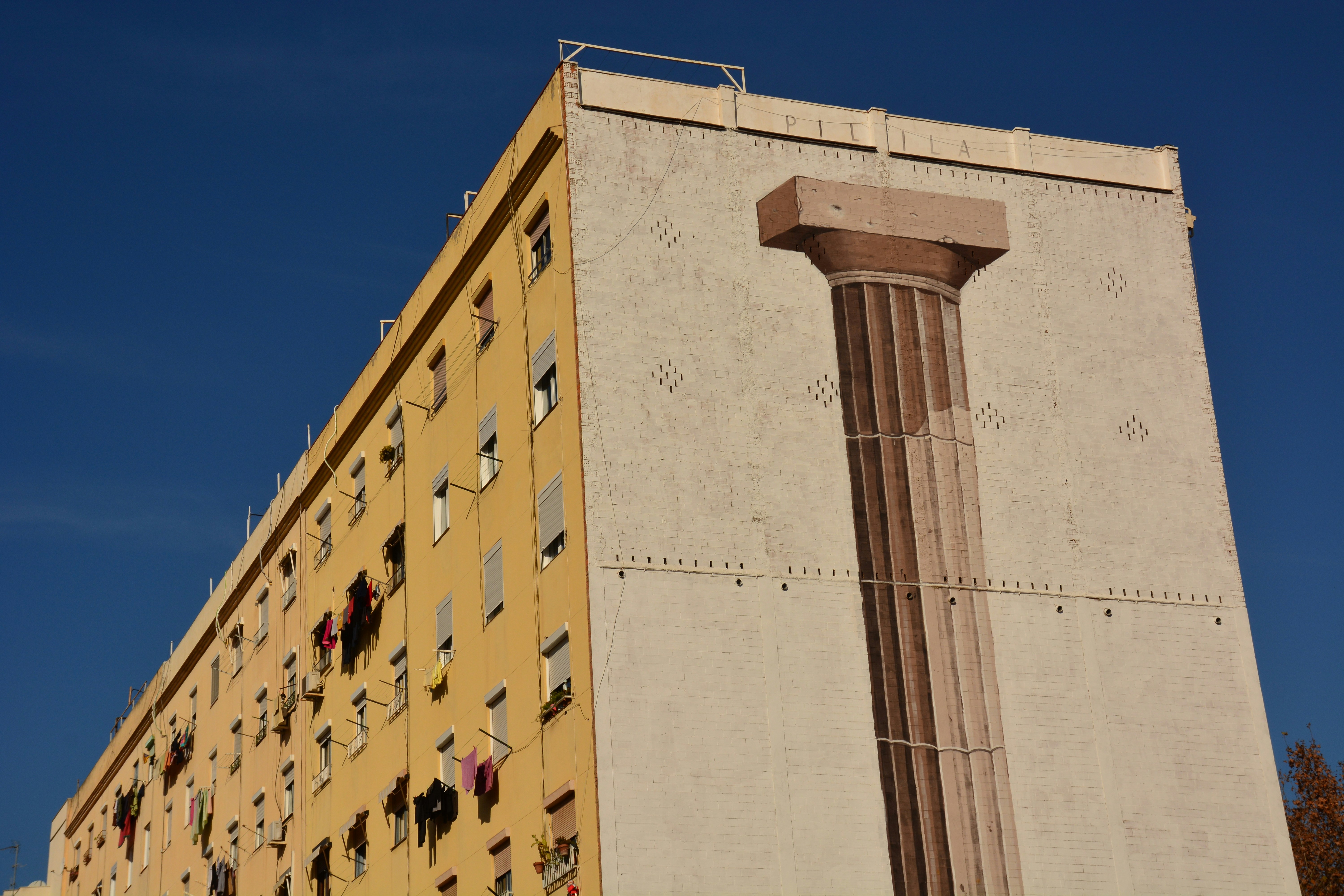 A tall building with a tall column in front of it