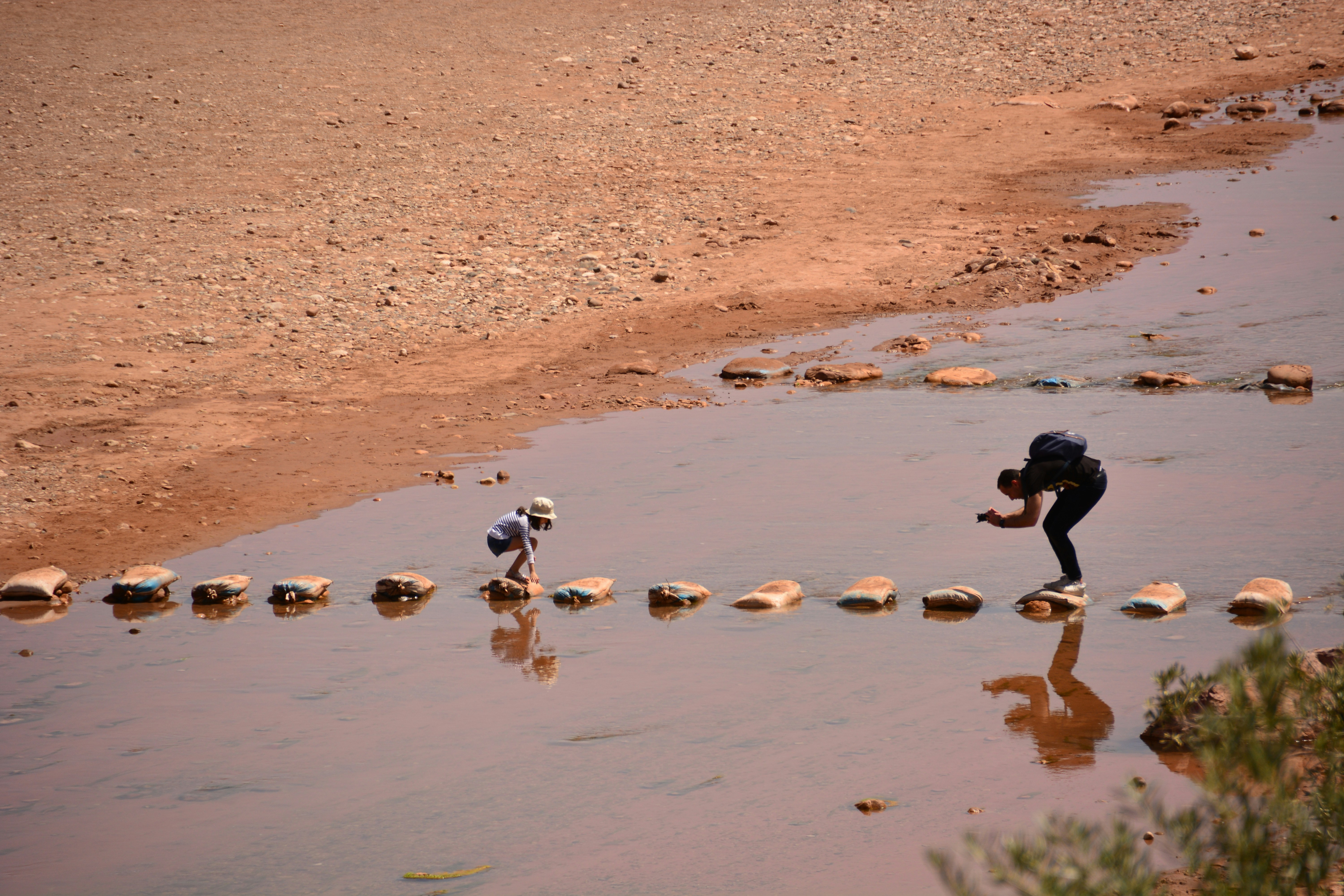 A couple of people that are standing in the water