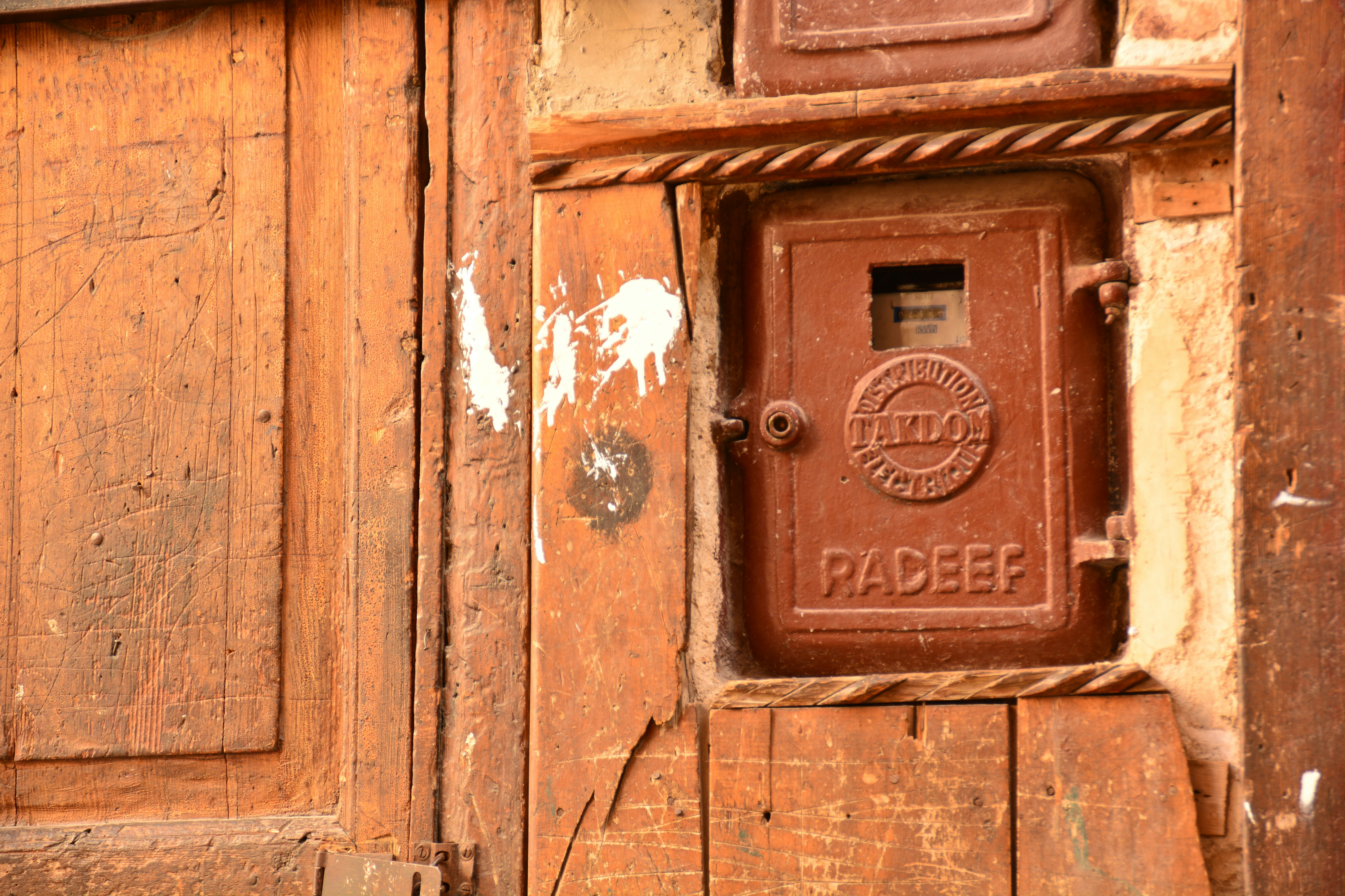 An old wooden door with a mailbox on it