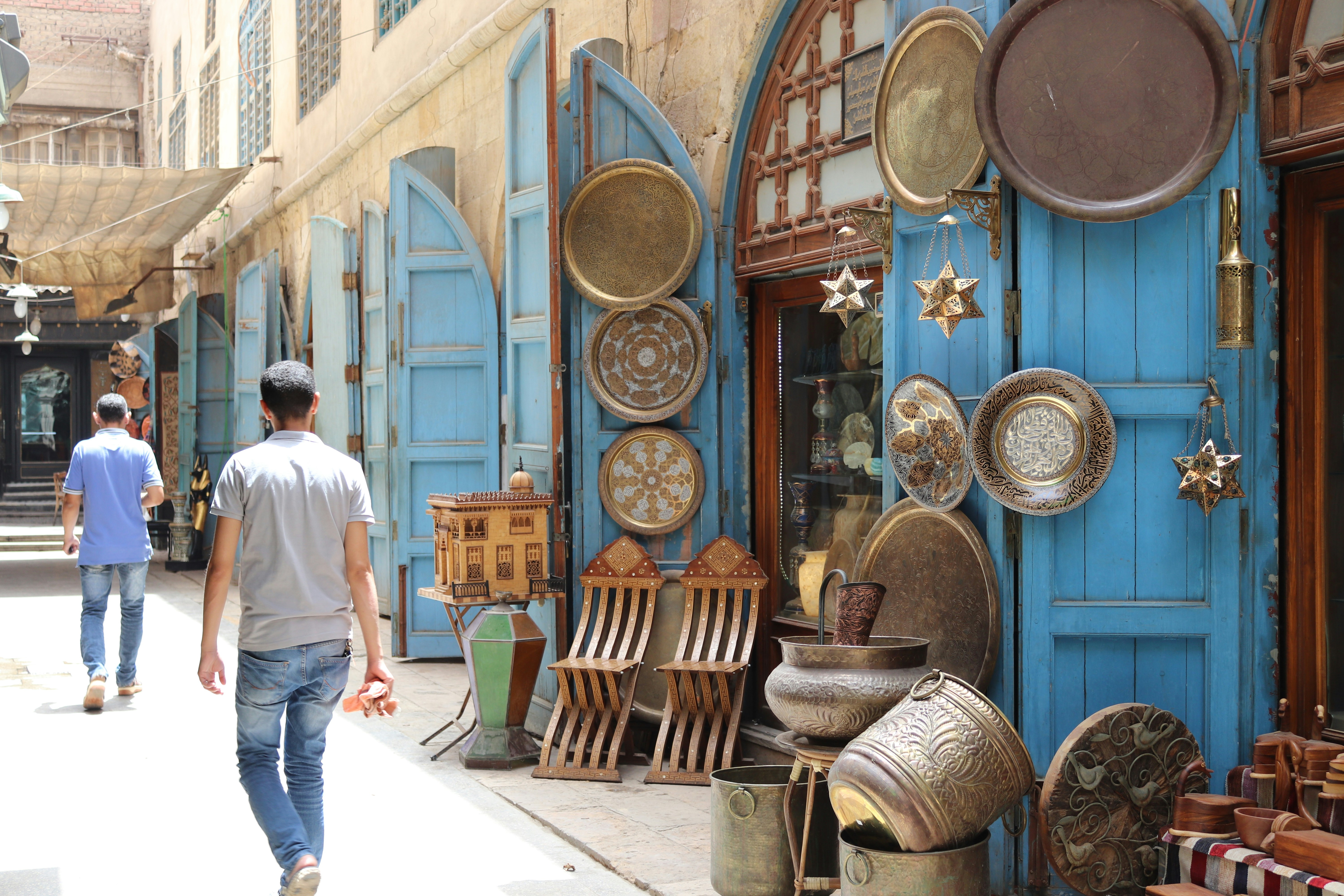 A man walking down a street past a store