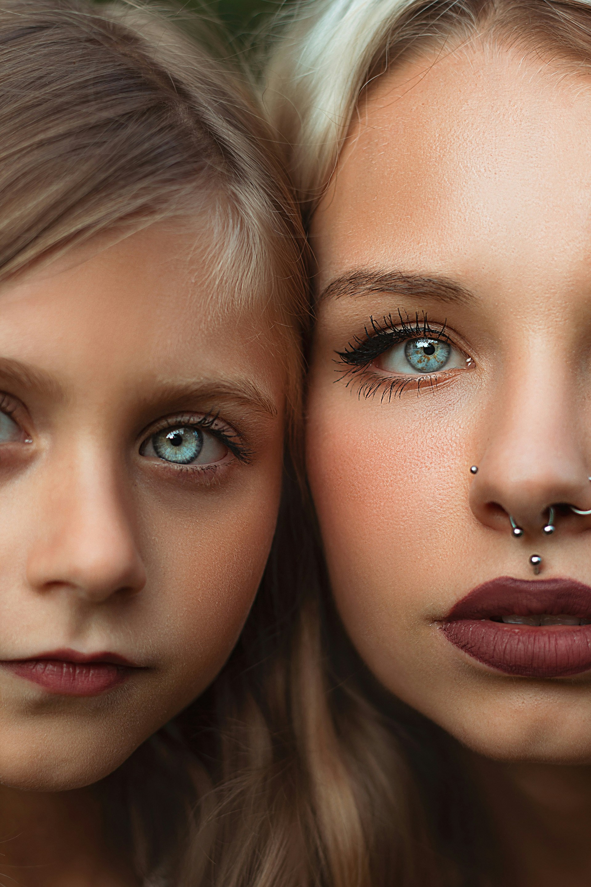 Two beautiful young women with piercings on their nose