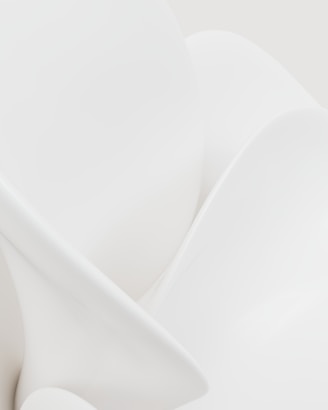 A close up of a white object with a white background