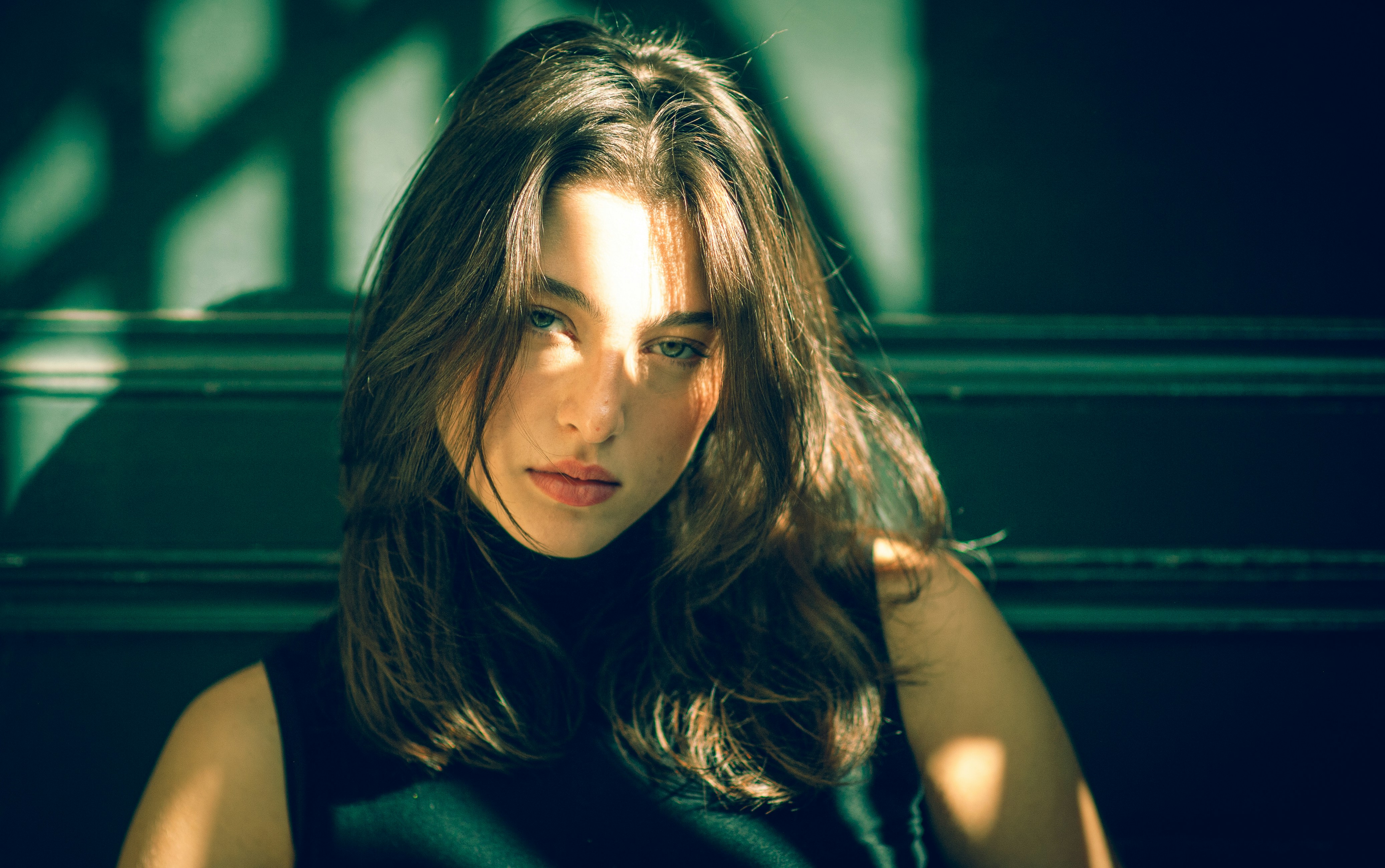 A woman in a black dress sitting down