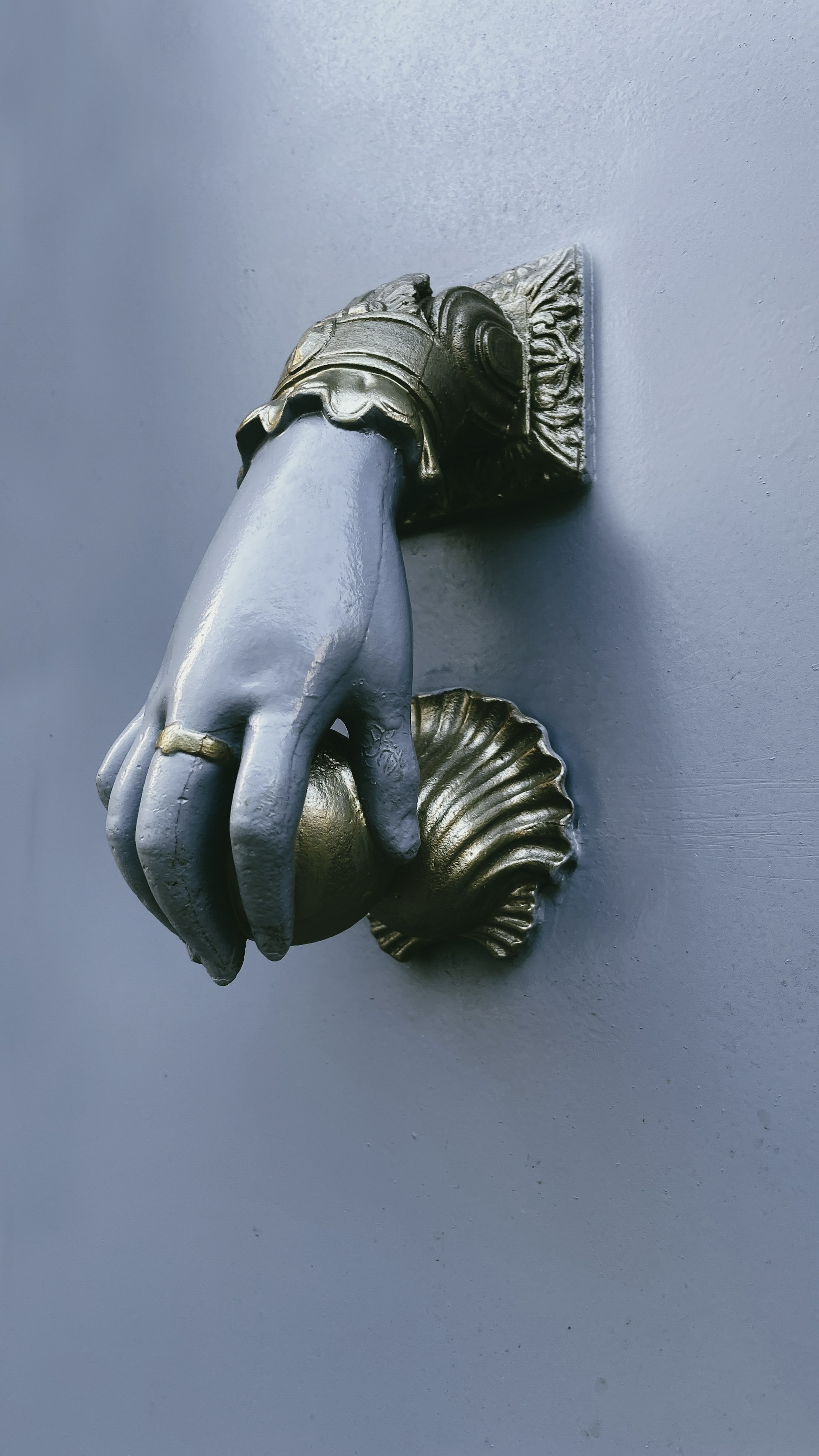 A pair of gloves hanging on a door handle