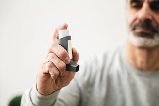 A man holding a cell phone in his right hand