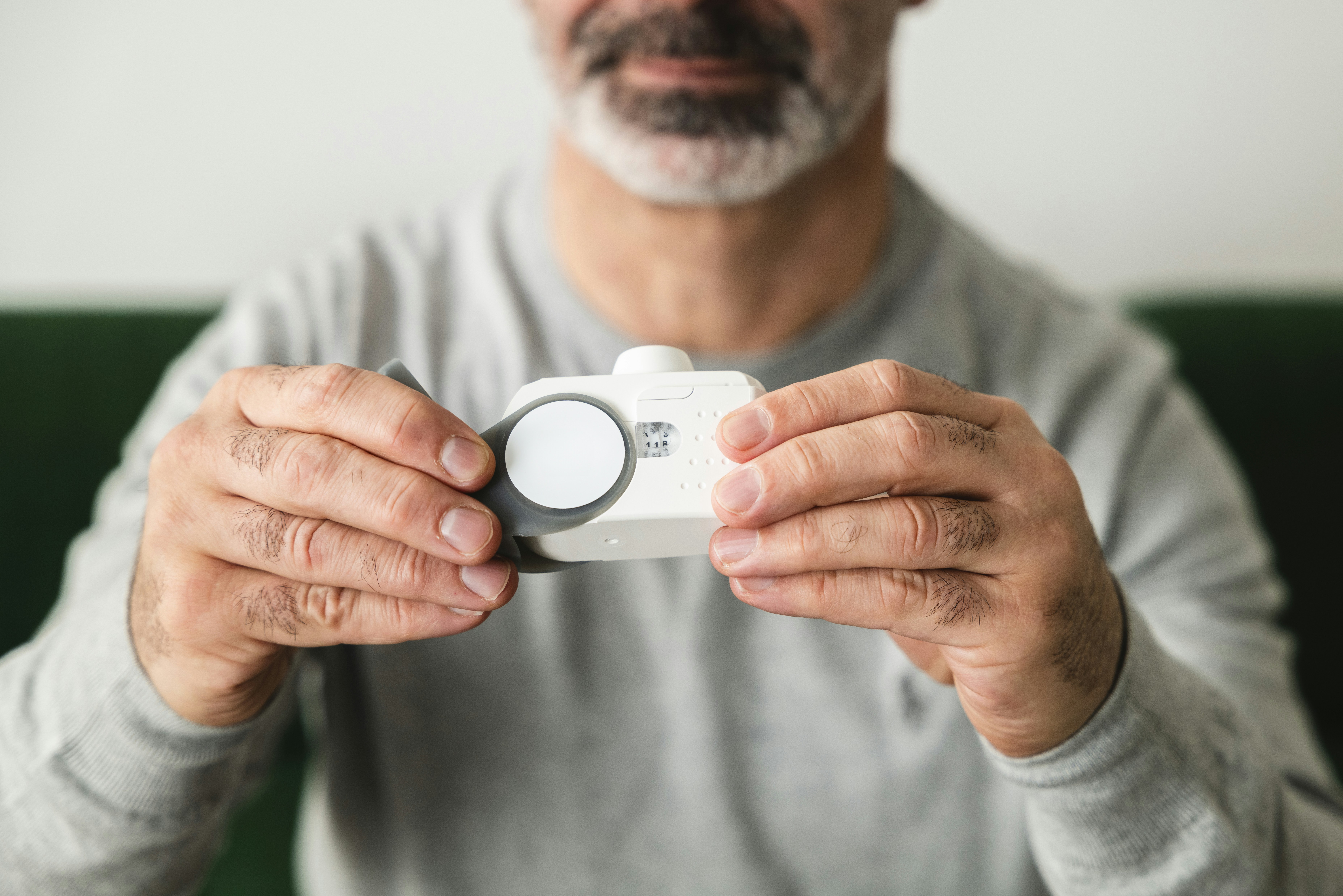 A man holding a camera in front of his face