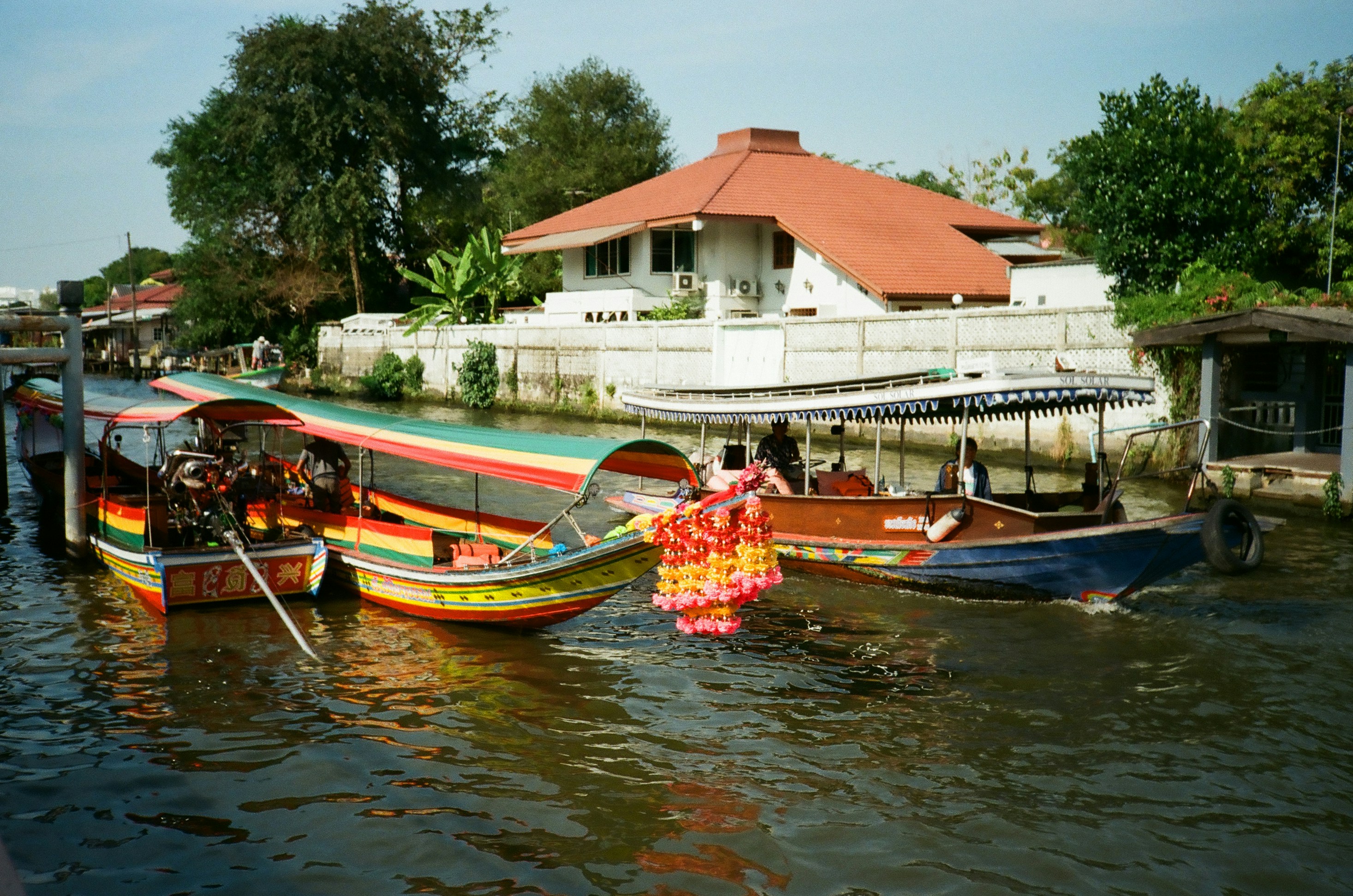 A group of people standing on a boat in the water