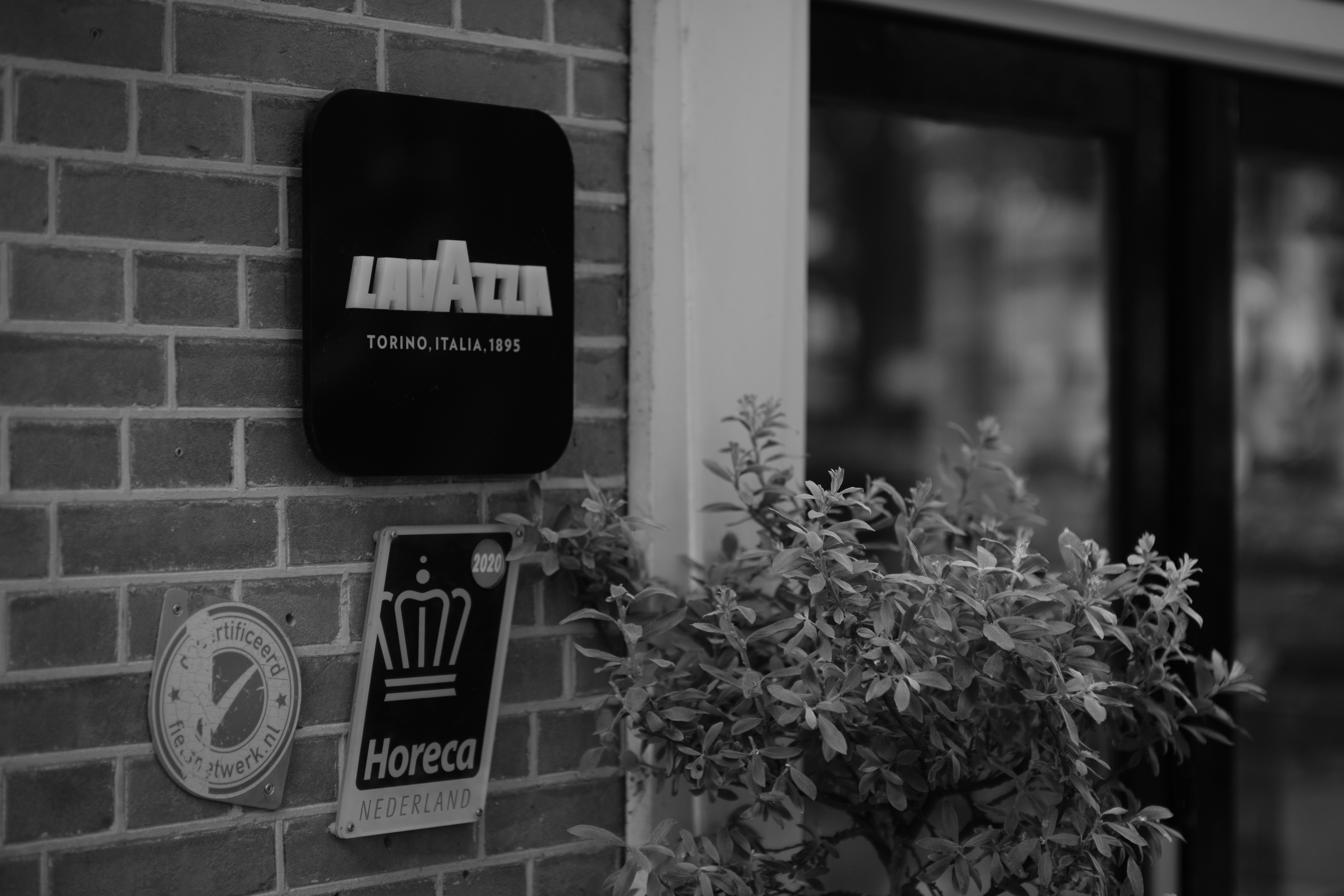 A black and white photo of a brick building