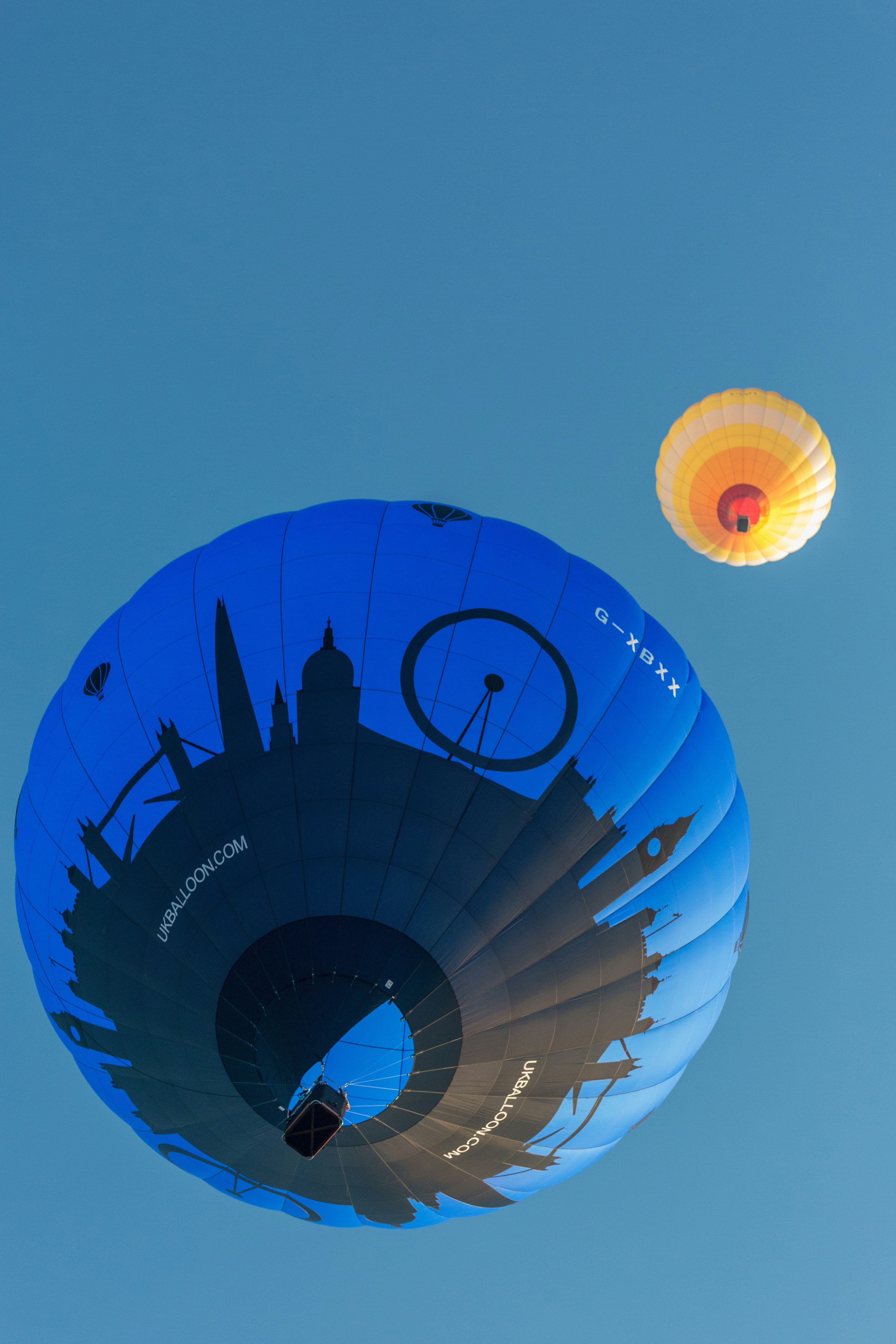 Two hot air balloons flying in the sky