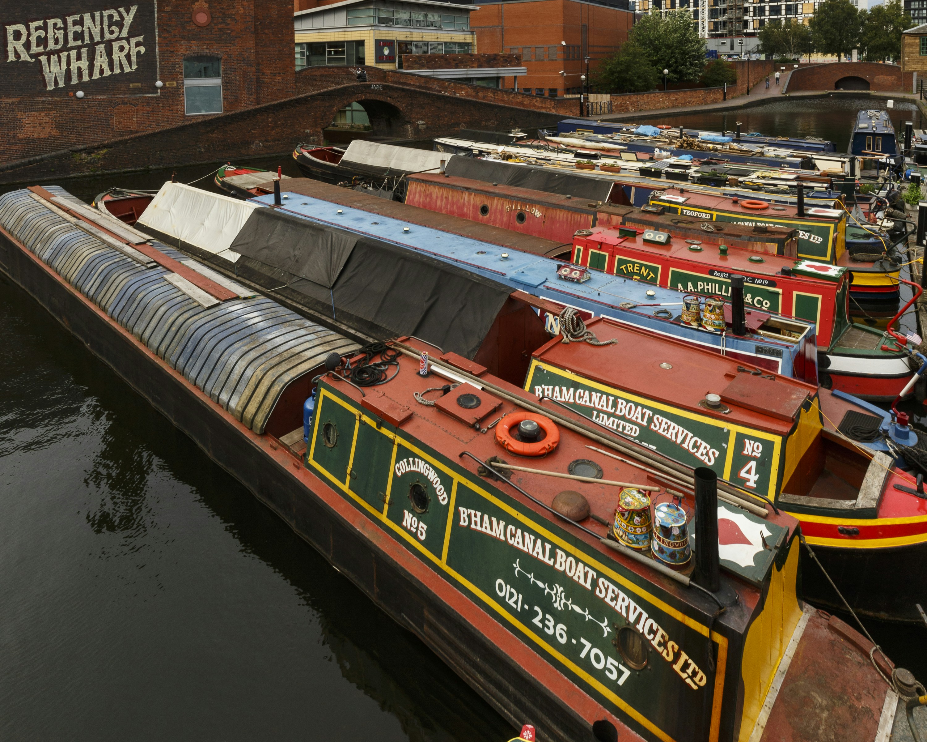 A long boat is docked in the water