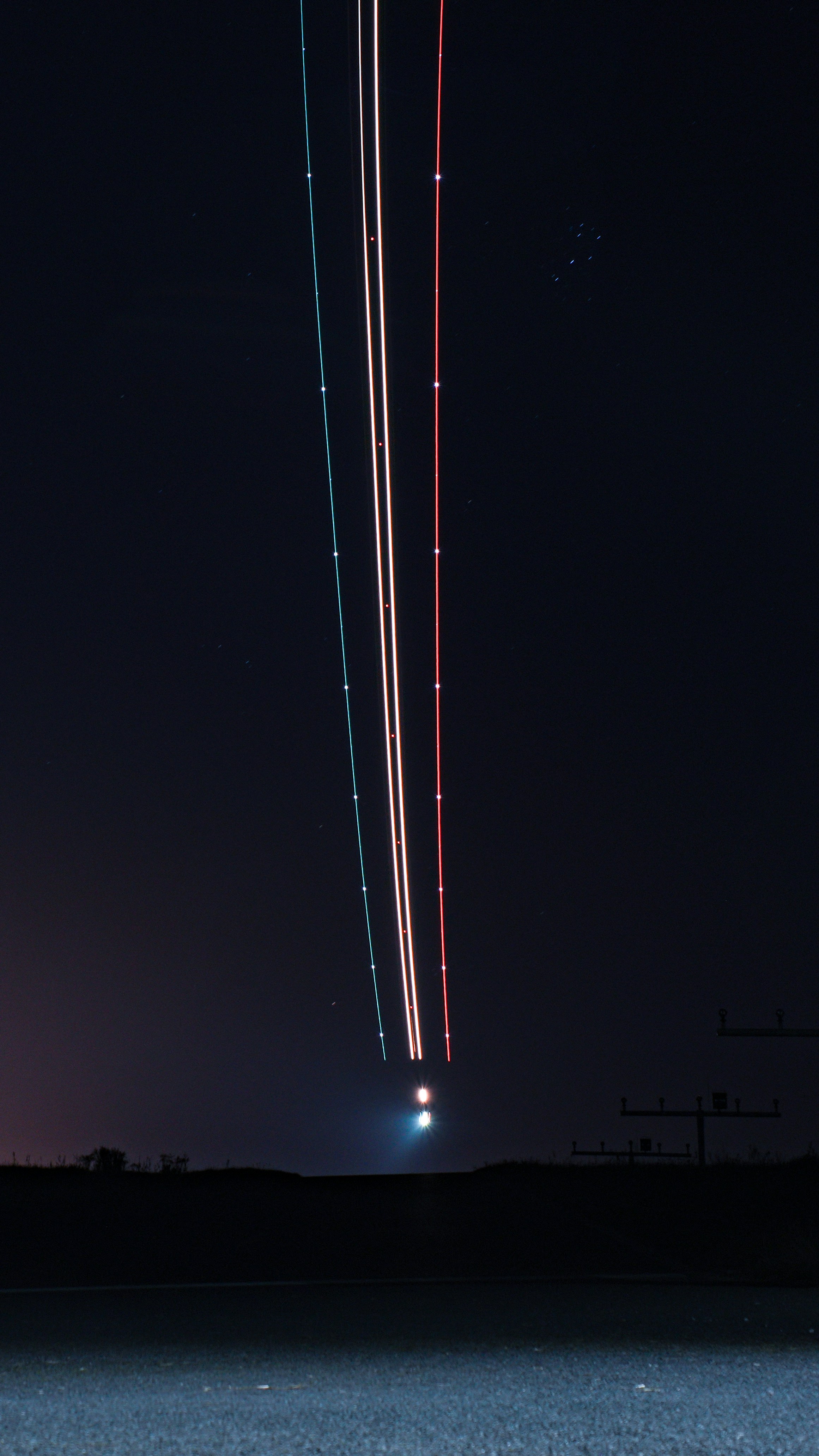 An airplane is flying in the night sky