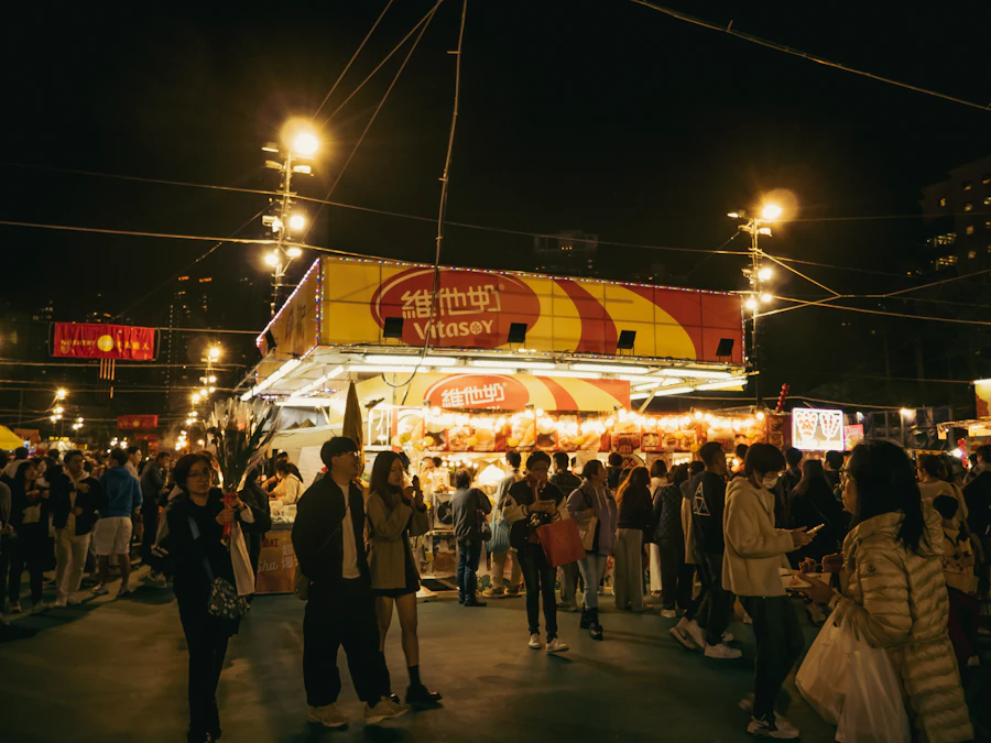 Crowded festival food stalls at Hong Kong harbourfront at night