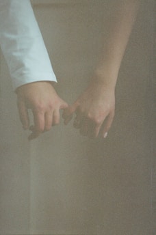 A couple holding hands while standing next to each other