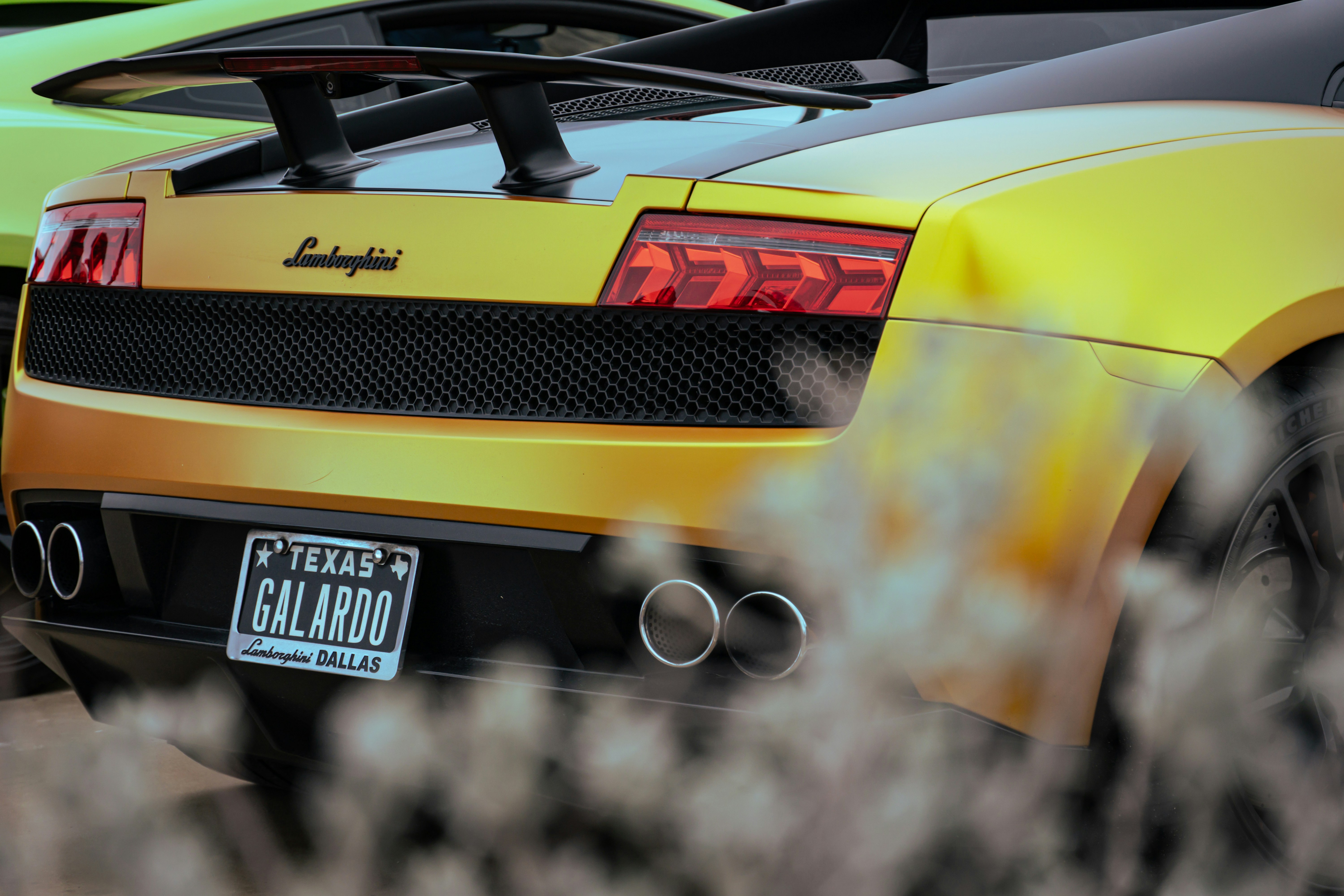 Two yellow sports cars parked next to each other
