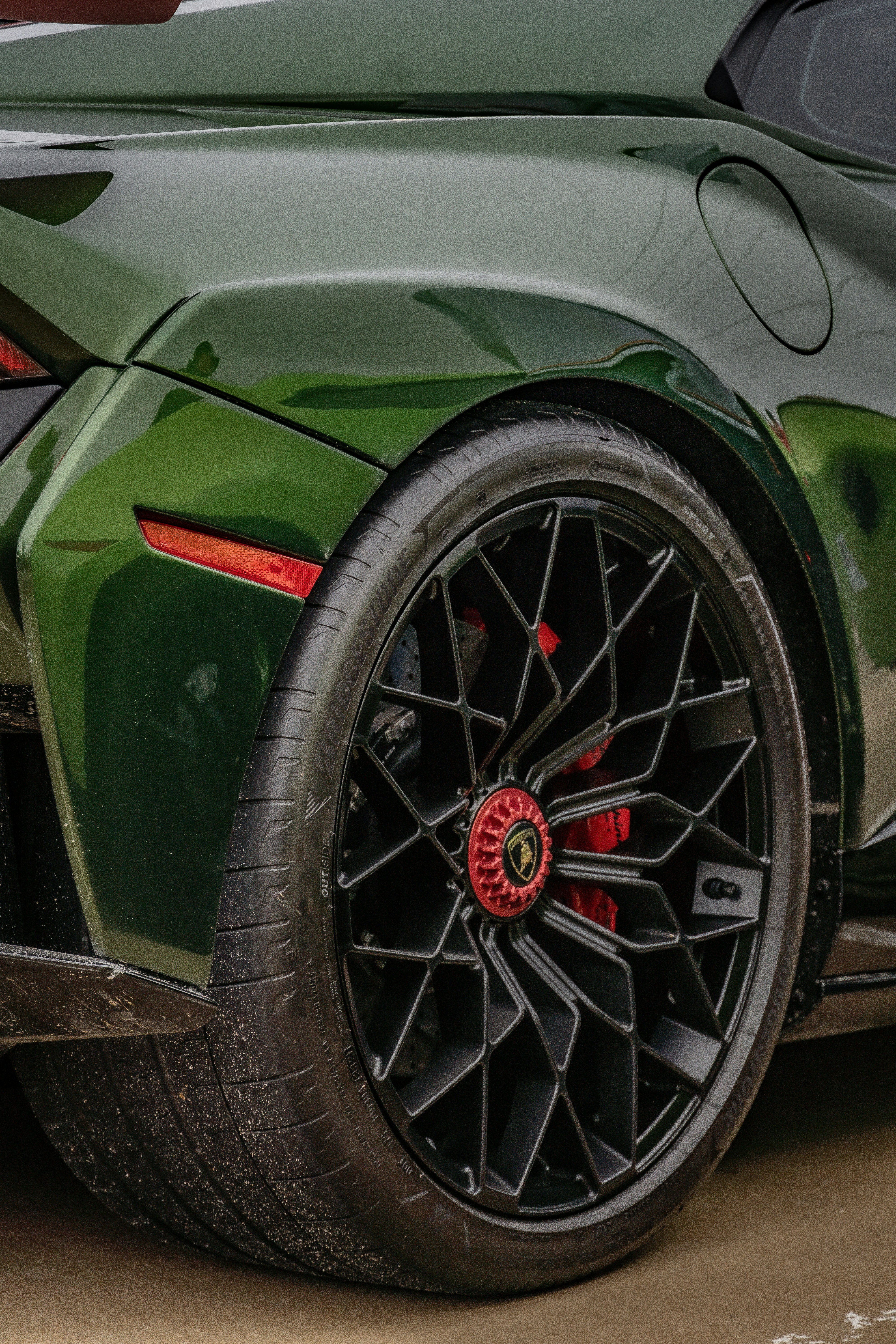 A green sports car parked in a parking lot