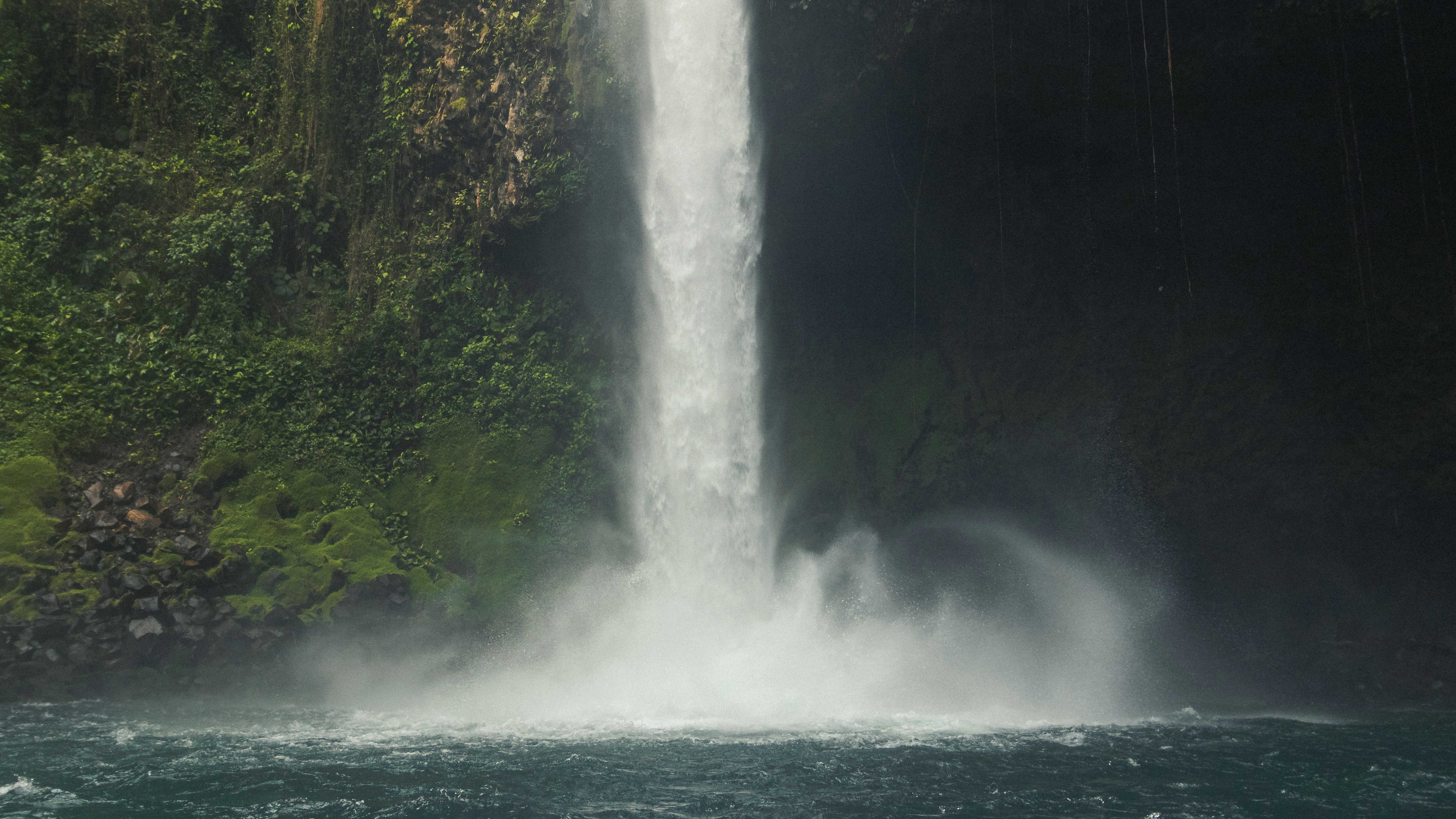 A waterfall with a boat in front of it