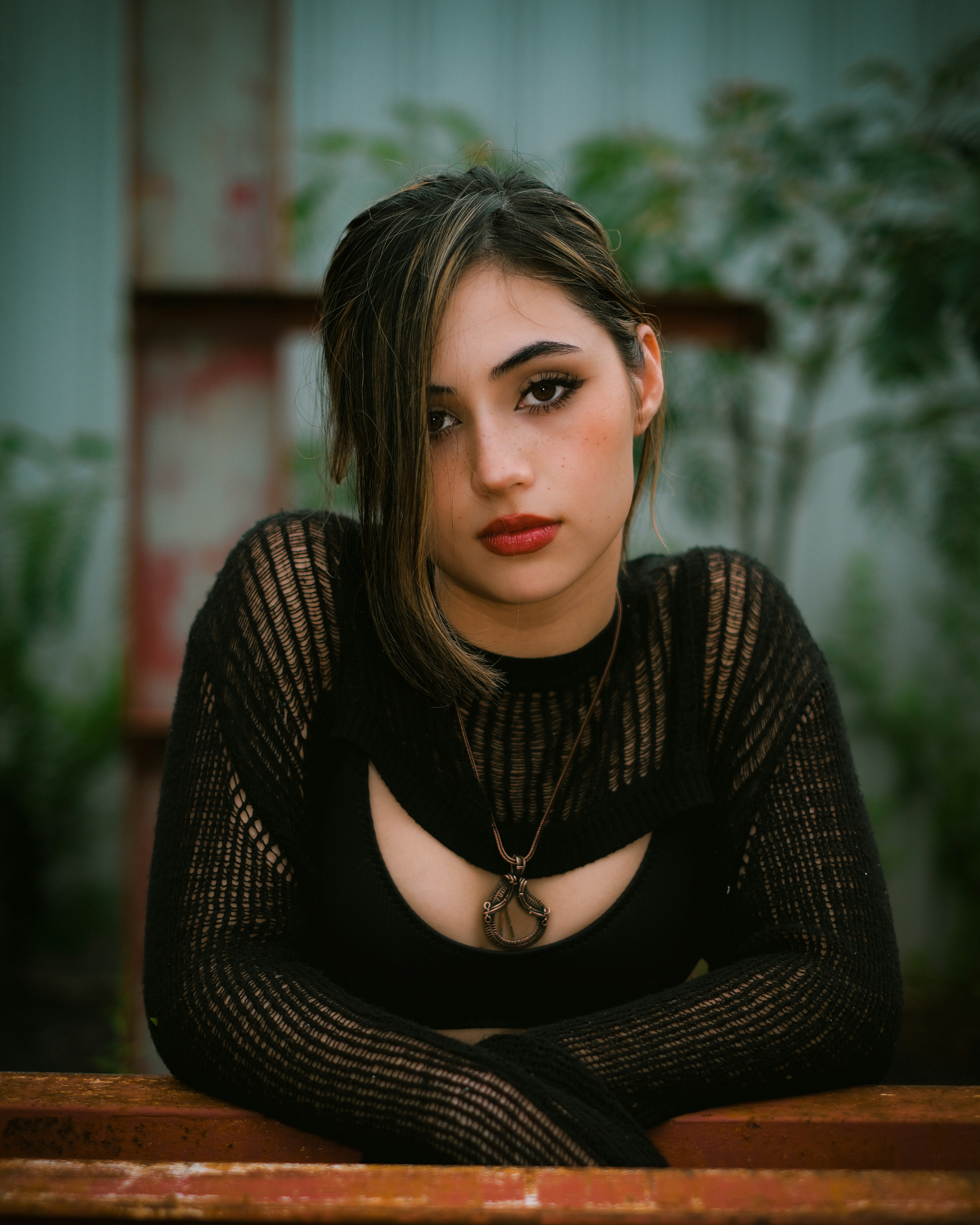 A woman sitting on a bench with her arms crossed