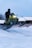 A person riding a snowmobile in the snow