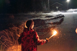 A couple of people standing next to each other holding sparklers