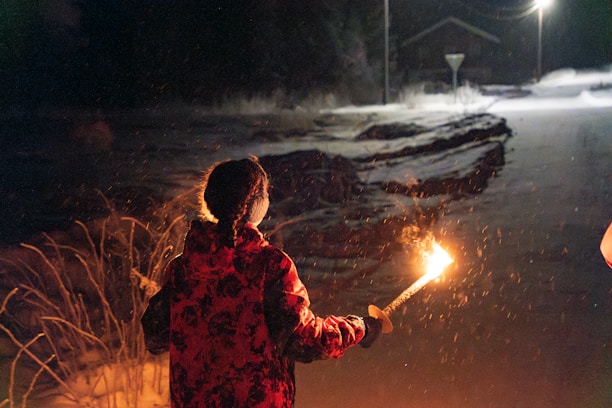 A couple of people standing next to each other holding sparklers