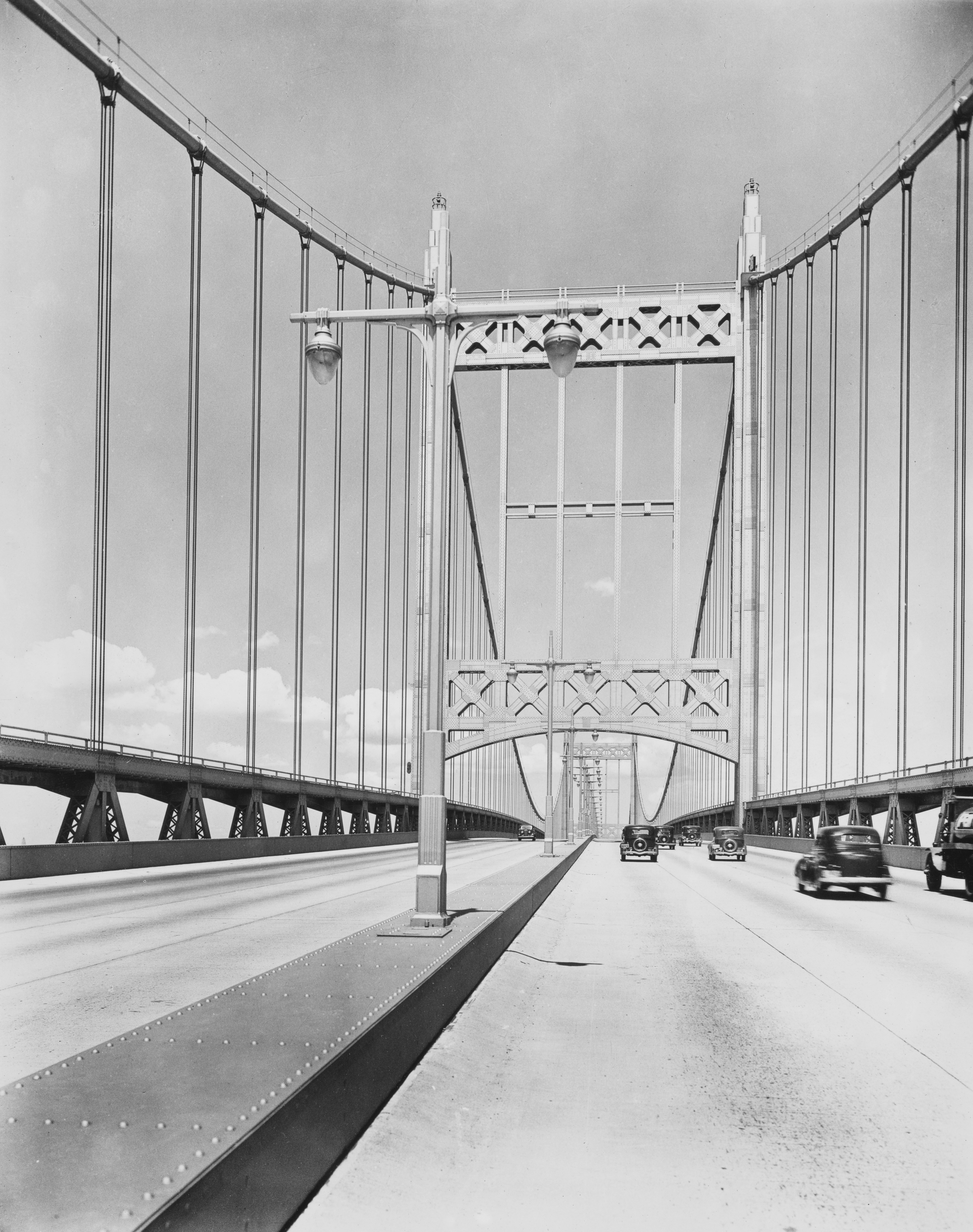 A black and white photo of a bridge