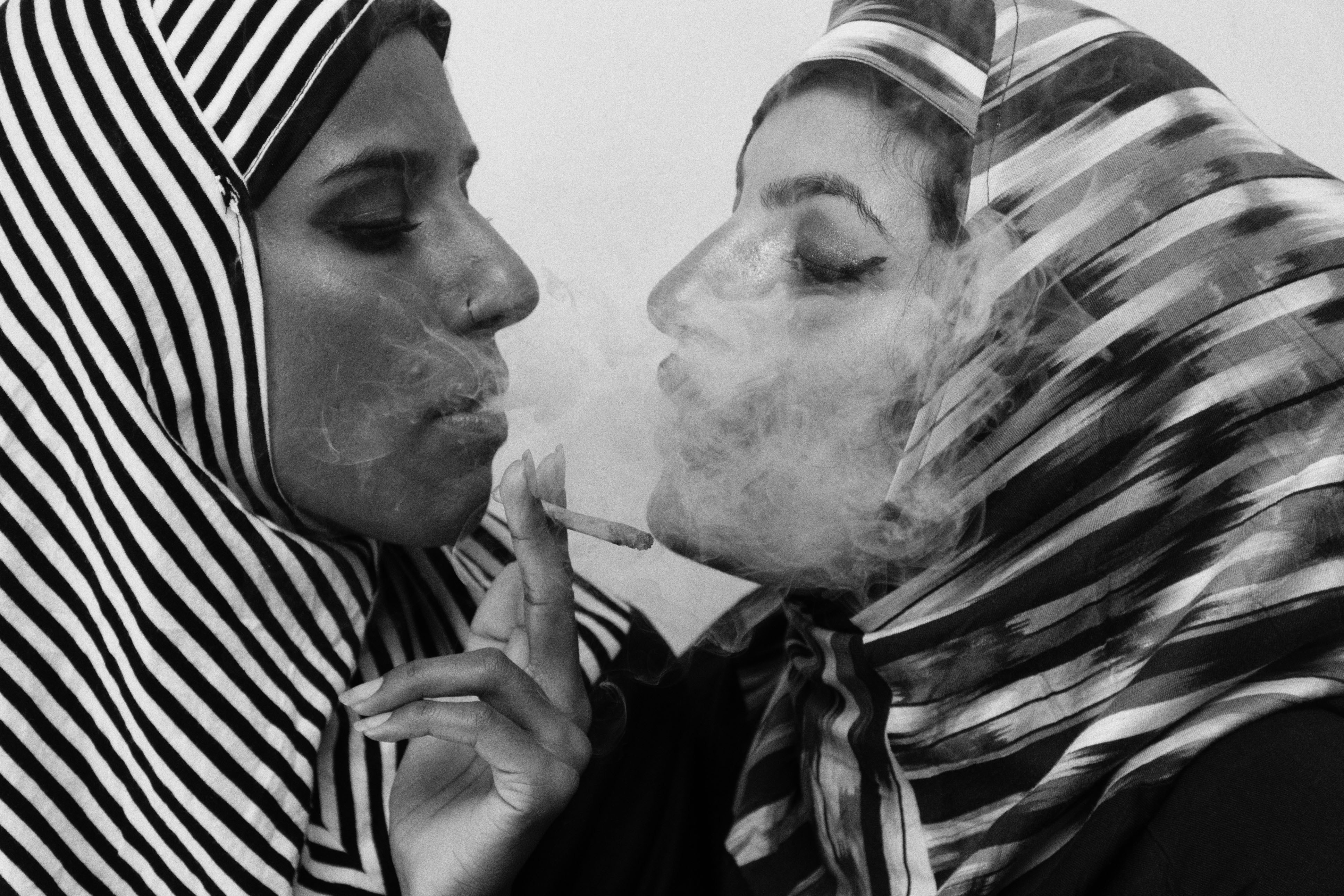 Two women with their faces covered in makeup