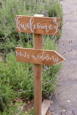 A wooden sign that has some writing on it
