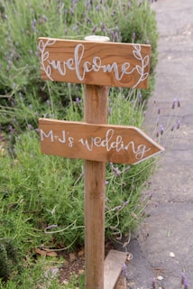 A wooden sign that has some writing on it